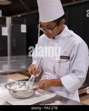 Pfc. Tyquanda Dennis, with the 275th Quartermaster Company, Fort Pickett, Va., mixes ingredients for a tuile (baked wafer) for her entry during the Armed Forces Junior Chef of the Year competition during the 41st Annual Military Culinary Arts Competitive Training Event at the Joint Culinary Center of Excellence, March 6, 2016, at Fort Lee, Va. Dennis, who has been on the U.S. Army Reserve Culinary Arts Team for only three days, scored a bronze medal in her first competition. (U.S. Army photo by Timothy L. Hale/Released) Stock Photo