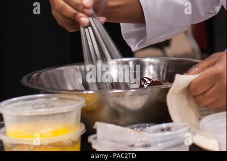 Pfc. Tyquanda Dennis, with the 275th Quartermaster Company, Fort Pickett, Va., mixes eggs and chocolate for her entry during the Student Chef of the Year competition during the 41st Annual Military Culinary Arts Competitive Training Event at the Joint Culinary Center of Excellence, March 6, 2016, at Fort Lee, Va. Dennis, who has been on the U.S. Army Reserve Culinary Arts Team for only three days, scored a bronze medal in her first competition. (U.S. Army photo by Timothy L. Hale/Released) Stock Photo