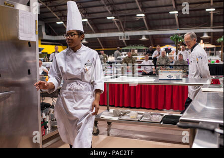 Pfc. Tyquanda Dennis, with the 275th Quartermaster Company, Fort Pickett, Va. moves to the refrigerator during the Armed Forces Junior Chef of the Year competition during the 41st Annual Military Culinary Arts Competitive Training Event at the Joint Culinary Center of Excellence, March 6, 2016, at Fort Lee, Va. Dennis, who has been on the U.S. Army Reserve Culinary Arts Team for only three days, scored a bronze medal in her first competition. (U.S. Army photo by Timothy L. Hale/Released) Stock Photo