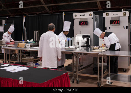 Pfc. Tyquanda Dennis, with the 275th Quartermaster Company, Fort Pickett, Va., center, and other junior chefs compete in the Armed Forces Junior Chef of the Year competition during the 41st Annual Military Culinary Arts Competitive Training Event at the Joint Culinary Center of Excellence, March 6, 2016, at Fort Lee, Va. Dennis, who has been on the U.S. Army Reserve Culinary Arts Team for only three days, scored a bronze medal in her first competition. (U.S. Army photo by Timothy L. Hale/Released) Stock Photo