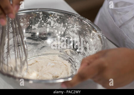 Pfc. Tyquanda Dennis, with the 275th Quartermaster Company, Fort Pickett, Va., mixes ingredients for a tuile (baked wafer) for her entry during the Armed Forces Junior Chef of the Year competition during the 41st Annual Military Culinary Arts Competitive Training Event at the Joint Culinary Center of Excellence, March 6, 2016, at Fort Lee, Va. Dennis, who has been on the U.S. Army Reserve Culinary Arts Team for only three days, scored a bronze medal in her first competition. (U.S. Army photo by Timothy L. Hale/Released) Stock Photo