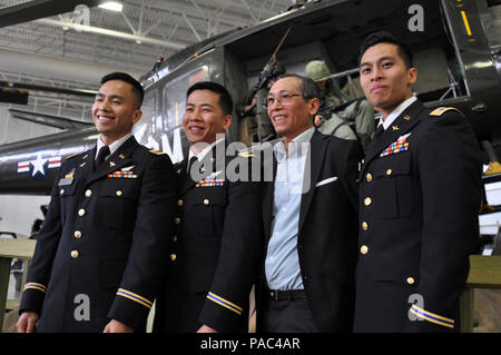 New Jersey Army National Guard Warrant Officers Alvin Bui, left, Daniel Bui, and Tu Bui with their father, Joseph Bui on March 3 after the brothers became what are believed to be the first brothers to graduate on the same day from the U.S. Army Initial Rotary Wing Training course to become Army aviators. Joseph Bui, who served alongside American forces during the Vietnam War as an infantryman with the South Vietnamese Army, brought his family to the United States in 1994 in search of better opportunities for his children. (Army National Guard photo by Staff Sgt. Wayne Woolley/Released) Stock Photo