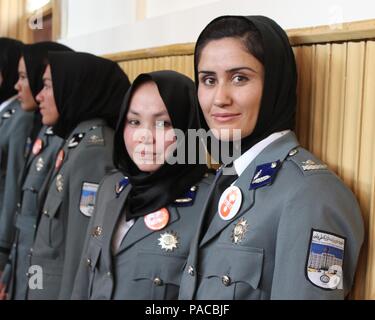 Women serving in the Afghan National Police wait to be recognized during the Ministry of the Interior International Women’s Day celebration in Kabul, Afghanistan. The women were among the 389 graduates of Basic Police Officer Training in Sivas, Turkey. During the duration of the course, women learned weapons handling, driver's training, first aid, ethics and values, basic rights of women victims, effects of crimes on victims, traffic policing computer, self-defense and other training related to being a policewoman in Afghanistan. (U.S. military photo by Lt. Charity Edgar/Released) Stock Photo