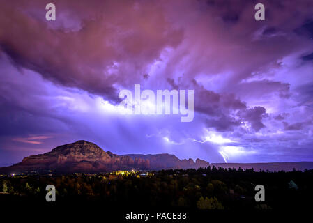 A summer monsoon in Sedona Arizona brings large lightning strikes across the sky Stock Photo