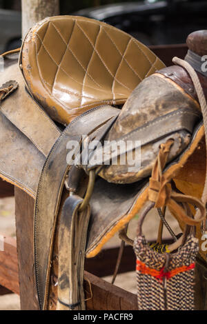 rustic horse saddle. This worn out leather saddle shows years of intense use Stock Photo