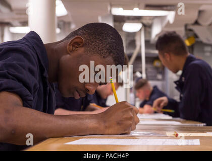 160317-N-GW139-008  WATERS NEAR GUAM (Mar. 17, 2016) - Culinary Specialist Seaman Kenya Hunter, takes an advancement exam on the mess decks aboard Arleigh Burke-class guided missile destroyer (DDG 62). Fitzgerald is on patrol in the 7th Fleet area of operations in support of security and stability in the Indo-Asia-Pacific. (U.S. Navy photo by Mass Communication Specialist 3rd Class Eric Coffer/Released) Stock Photo