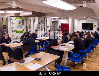 160317-N-GW139-018  WATERS NEAR GUAM (Mar. 17, 2016) - Sailors aboard Arleigh Burke-class guided missile destroyer USS Fitzgerald (DDG 62) take an advancement exam on the mess decks. Fitzgerald is on patrol in the 7th Fleet area of operations in support of security and stability in the Indo-Asia-Pacific. (U.S. Navy photo by Mass Communication Specialist 3rd Class Eric Coffer/Released) Stock Photo