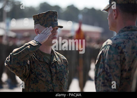 Cpl. Joseph Currey, left, salutes Lt. Col. Jeremy Winters, right, during an award ceremony at Marine Corps Air Station Cherry Point, N.C., March 1, 2016. Currey was awarded the Navy and Marine Corps Commendation Medal for his actions after witnessing an ambulance wreck. Currey demonstrated his devotion to serving others as he placed the well-being of the injured personnel above his own by running towards the scene of an accident and rendering aide to those need. Currey is an air support operations operator with Marine Aviation Support Squadron 1. (U.S. Marine Corps photo by Cpl. Austin A. Lewi Stock Photo