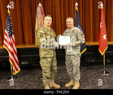 Maj. Gen. Ricky Waddell, commanding general of the 76th Operational Readiness Command, presented an award to Col. Anthony Demolina, during a retirement ceremony held at Fort Douglas, Utah, March 13. Stock Photo