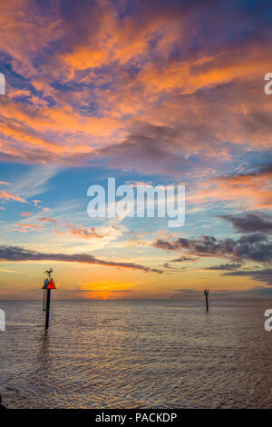 Colorful sunset over the Gulf of Mexico and the Gulf Intracoastal Waterway at the Venice Jetty in Venice Florida Stock Photo