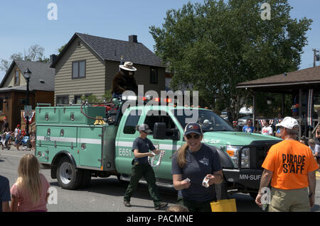 A US Forest Service truck in a July 4th parade with Smokey The Bear Stock Photo