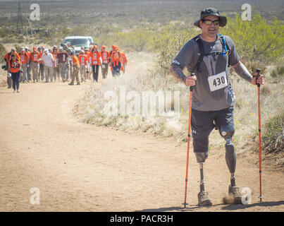 Former Navy Special Operations Master Chief Harold Bologna, of Virginia Beach, Va., walks ahead of retired U.S. Army Col. and Bataan Death March Survivor Ben Skardon and his entourage during the 27th annual Bataan Memorial Death March at White Sands Missile Range, N.M., March 20, 2016. Bologna lost his legs when he stepped on a land mine in Afghanistan in October, 2015 - just five months prior to this. Skardon, 98, is the only Bataan survivor that walks in the march. Both men walked more than eight miles. (U.S. Army photo by Staff Sgt. Ken Scar) Stock Photo