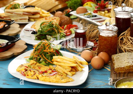 Breakfast omelette with french fries and garnish Stock Photo