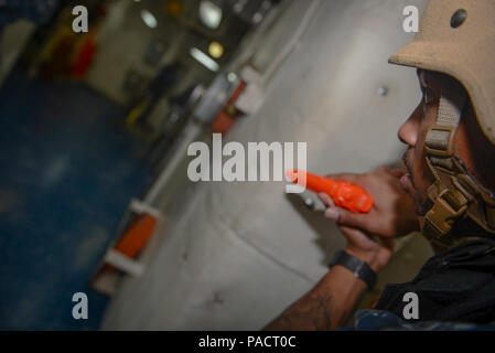 MAYPORT, Fla. (August 8, 2017) Master-at-Arms 1st Class Deandre Forbes checks around a corner before approaching the ship store of the amphibious ship USS Iwo Jima (LHD 7) during an anti-terrorism force protection drill. Iwo Jima is in port conducting a scheduled continuous maintenance availability in preparation for their upcoming deployment. Stock Photo