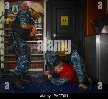 MAYPORT, Fla. (August 8, 2017) Sailors detain a simulated active shooter on the mess deck of the amphibious assault ship USS Iwo Jima (LHD 7) during an anti-terrorism force protection drill. Iwo Jima is in port conducting a scheduled continuous maintenance availability in preparation for their upcoming deployment. Stock Photo