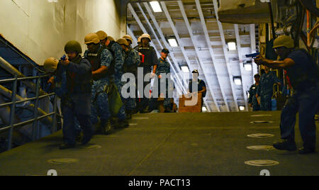 MAYPORT, Fla. (August 8, 2017) Sailors descend the upper vehicle stowage ramp aboard the amphibious assault ship USS Iwo Jima (LHD 7) during an anti-terrorism force protection drill. Iwo Jima is in port conducting a scheduled continuous maintenance availability in preparation for their upcoming deployment. Stock Photo