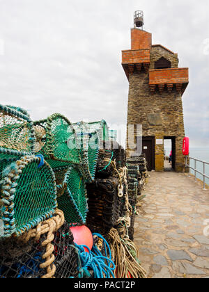 Lobster pots in front of the Rhenish Tower on the wall of Lynmouth Harbour, Devon, England, UK Stock Photo