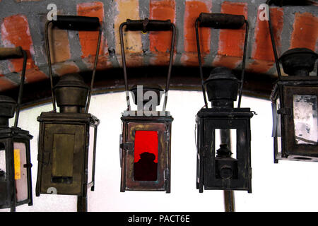 Old antique lanterns hanging on wall Stock Photo