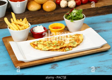 Breakfast omelette with french fries and garnish Stock Photo