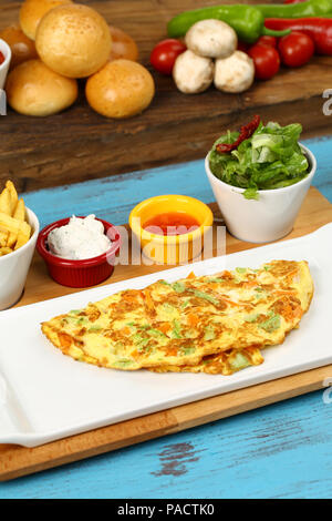 Breakfast omelette with french fries and garnish Stock Photo