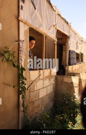 Arsal, Lebanon. 11th July, 2018. Syrian Laila Huria looking out the window in a refugee camp in the Lebanese town of Arsal. She and her family want to return to their hometown of Flita next week. Credit: Jan Kuhlmann/dpa/Alamy Live News Stock Photo