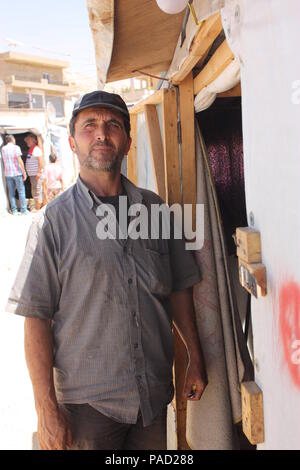 Arsal, Lebanon. 11th July, 2018. A Syrian that goes by the name of Abu Mohammed standing before his accomodation in a refugee camp in the Lebanese town of Arsal. Credit: Jan Kuhlmann/dpa/Alamy Live News Stock Photo