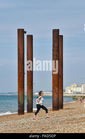 Brighton UK 22nd July 2018 - A beautiful hot sunny day on Brighton beach by the West Pier as the heatwave weather continues throughout parts of Britain Credit: Simon Dack/Alamy Live News Credit: Simon Dack/Alamy Live News Stock Photo
