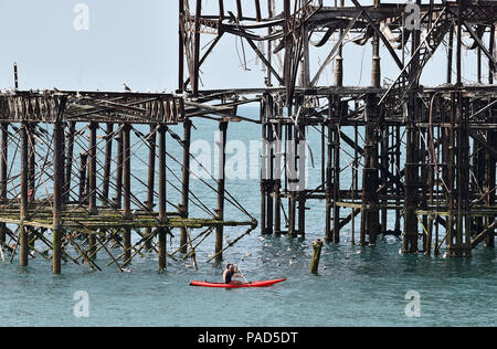 Brighton UK 22nd July 2018 - A beautiful hot sunny day to paddle around the West Pier in Brighton as the heatwave weather continues throughout parts of Britain Credit: Simon Dack/Alamy Live News Credit: Simon Dack/Alamy Live News Stock Photo