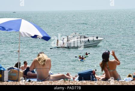 Brighton UK 22nd July 2018 - Brighton beach is packed both on and off shore in hot sunshine as the heatwave weather continues throughout parts of Britain Credit: Simon Dack/Alamy Live News Stock Photo