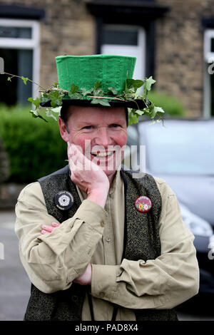 Littleborough, UK. 22nd July, 2018. A folk dancer wearing a green top hat at the annual Rushbearing festival reviving the tradition of carrying the rushes to the local church dating back to a time when the church floors where earthen and the rushes were used to cover them for insulation. Littleborough,22nd July, 2018 (C)Barbara Cook/Alamy Live News Credit: Barbara Cook/Alamy Live News Stock Photo