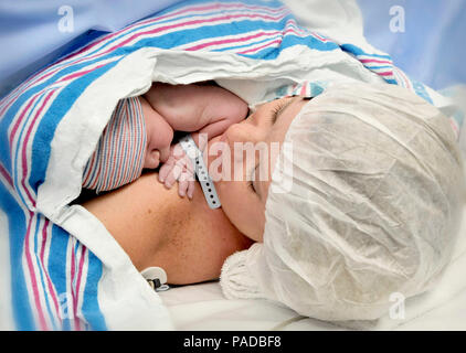 Kristy Goldberg, a native of Delanco, New Jersey, holds newborn son, Kaleb Goldberg, for the first ever Skin-to-Skin Contact (SSC) after cesarean delivery (C-section) performed at William Beaumont Army Medical Center, March 21. The completion of the first SSC after C-section opens the doors to future SSC after C-section candidates as part of WBAMC course to seeking national accreditation as a Baby-Friendly hospital. (U.S. Army photo by Enrique Escajeda) Stock Photo