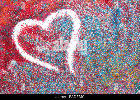 Beautiful heart background on colored sand made from seashells of different shapes and stones Stock Photo