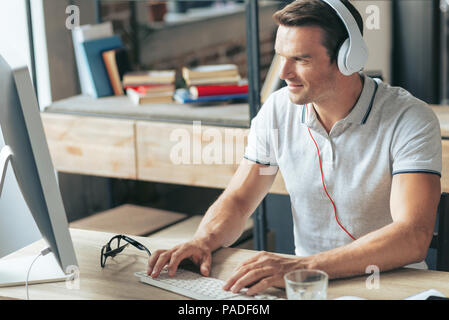 Smart nice man typing on the keyboard Stock Photo