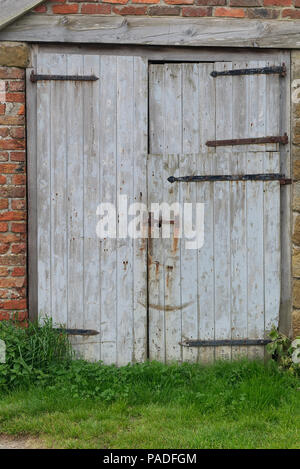 Rustic old wooden barn doors on a farm in late spring in the north of England, Yorkshire. Wood texture background. Stock Photo
