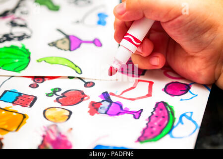 Child Hand With Red Felt Tip Pen Drawing Small Pictures On Paper Stock Photo Alamy