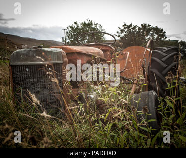 Old rusty tractor in a field on the Isle of Skye Stock Photo