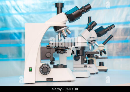 Four microscopes of different designs in the laboratory Stock Photo