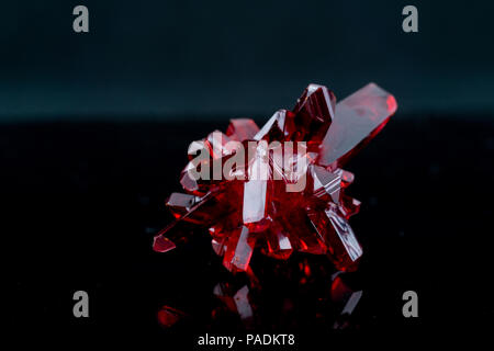 red crystal of natural origin. close up of crystals in ruby color on black  background Stock Photo