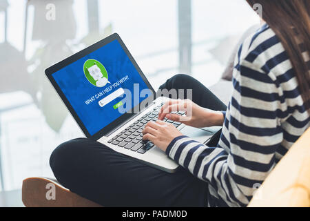 Asia woman ask chat bot function in app on laptop screen looking for customer support online shopping shop with apps,digital marketing concept,artific Stock Photo