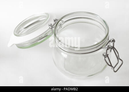 Glass jar with opened lid isolated on white Stock Photo