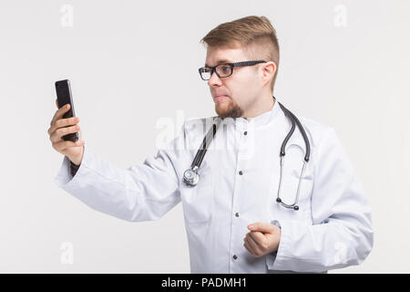 Young male doctor making photo on his phone Stock Photo