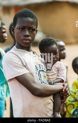 ACCRA, GHANA - MARCH 6, 2012: Unidentified Ghanaian woman with her little baby in the street in Ghana. Children of Ghana suffer of poverty due to the  Stock Photo