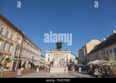 SZEGED, HUNGARY - JULY 2, 2018: People standing near Kossuth Lajos Sttatue in the city center of Szeged. Kossuth lajos is one of the 1848 Hungarian Re Stock Photo