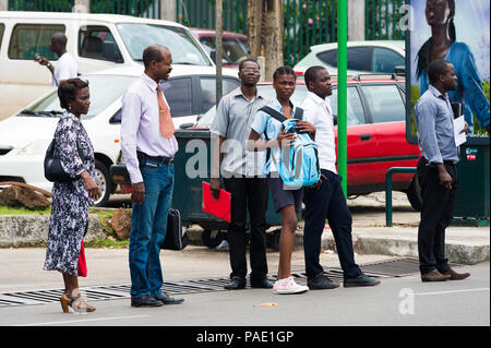 GABON - MARCH 6, 2013: Unidentified Gabonese people waiting for a bus on a bus stop in Gabon, Mar 6, 2013. People of Gabon suffer of poverty due to th Stock Photo