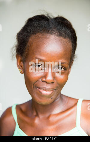 LIBREVILLE, GABON - MAR 6, 2013: Unidentified Gabonese girl smiles for the camera in Gabon, Mar 6, 2013. People of Gabon suffer of poverty due to the  Stock Photo