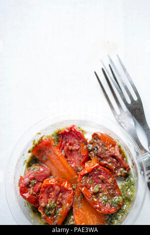 Sun dried tomatoes, red peppers with green pesto Stock Photo