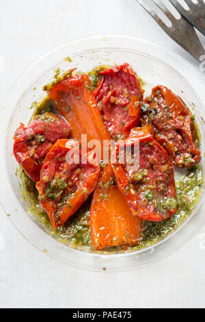 Sun dried tomatoes, red peppers with green pesto Stock Photo