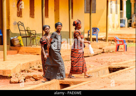 ACCRA, GHANA - MARCH 5, 2012: Unidentified Ghanaian women walk in the street in Ghana. People of Ghana suffer of poverty due to the unstable economic  Stock Photo