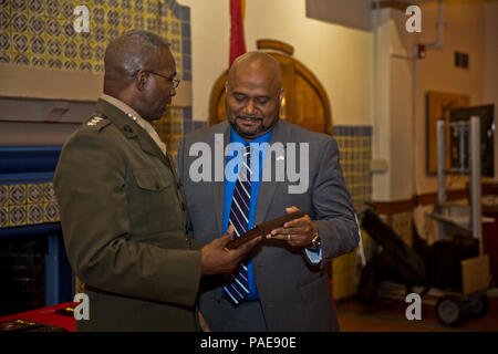 Mr. Uriel S. Hill, Jr., right, an anti-terrorism officer at Marine Corps Base Camp Butler, Camp Schwab, Okinawa, Japan, receives the 2015 Security and Emergency Services Civilian of the Year Award from Lt. Gen. Ronald Bailey, Deputy Commandant Plans, Polices, and Operations, at Marine Corps Recruit Depot San Diego, Calif., March 8, 2016. Hill was recognized for making a positive change in his command by improving work flow. (U.S. Marine Corps photo by Lance Cpl. Robert G. Gavaldon/Released) Stock Photo