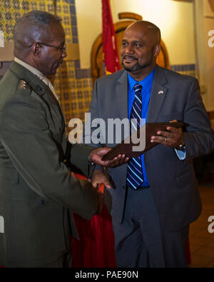 Mr. Uriel S. Hill, Jr., right, an anti-terrorism officer at Marine Corps Base Camp Butler, Camp Schwab, Okinawa, Japan, receives the 2015 Security and Emergency Services Civilian of the Year Award from Lt. Gen. Ronald Bailey, Deputy Commandant Plans, Polices, and Operations, at Marine Corps Recruit Depot San Diego, Calif., March 8, 2016. Hill was recognized for making a positive change in his command by improving work flow. (U.S. Marine Corps photo by Lance Cpl. Robert G. Gavaldon/Released) Stock Photo